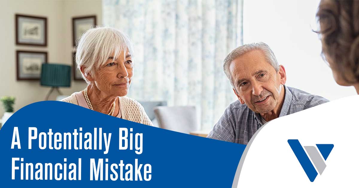 A nicely dressed older man and woman sitting in an office with their financial advisor.