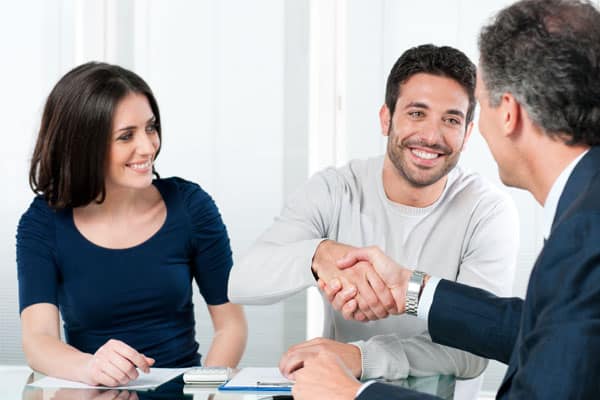 Looking for peace of mind in a turbulent world? You need a financial advisor that's committed to your success. We offer complete transparency and accountability while helping you maintain financial security in all market conditions. Contact us today for your free consultation at Virtus Wealth Management. Image of young couple smiling. Man shaking hands with financial advisor.