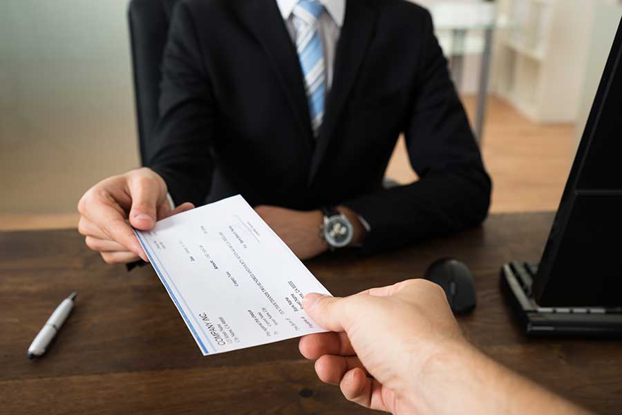 Businessman handing a check to another person