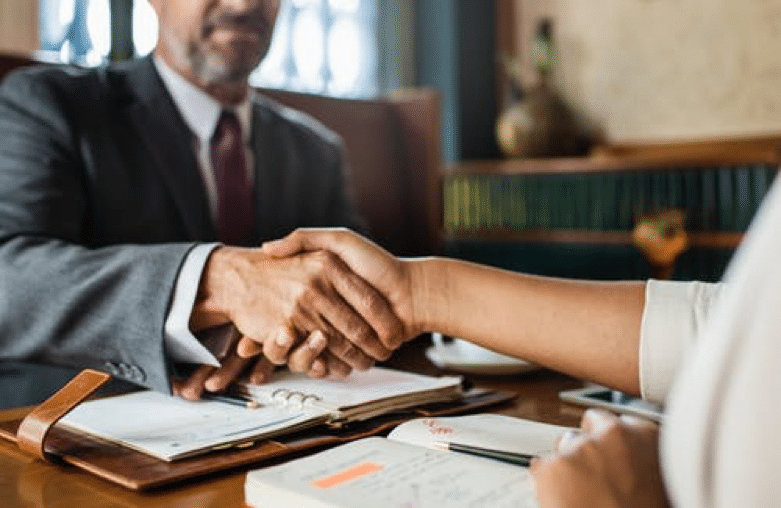 Handshake symbolizing trust and partnership, representing Virtus Wealth Management and the professional financial services offered on the website.