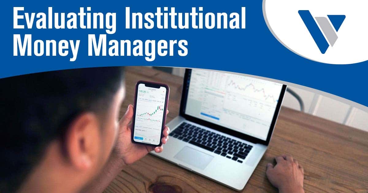 Man reviewing investment charts on a laptop while holding a smartphone
