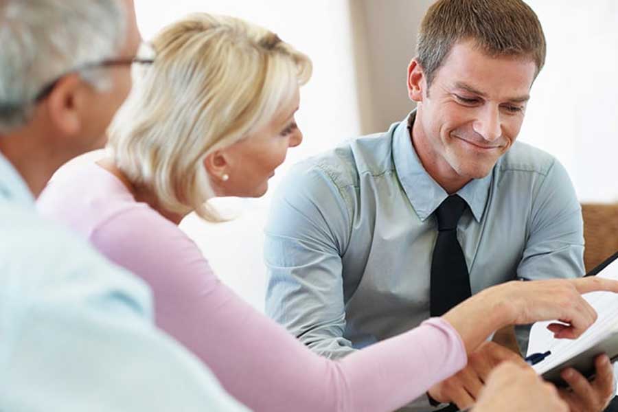 Adults reviewing paperwork during a retirement planning meeting