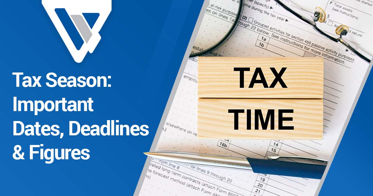 Tax documents with blocks, pen, glasses, and magnifying glass